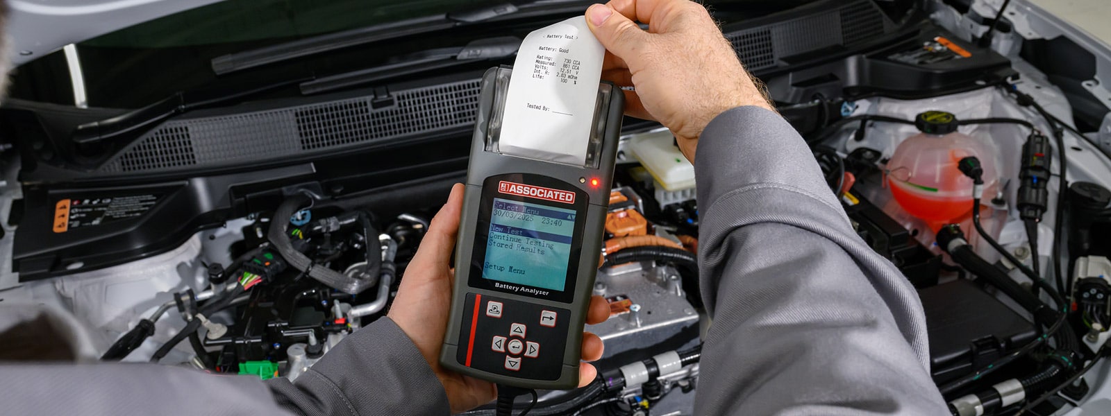 Mechanic installing brake pads on a vehicle in a workshop setting.