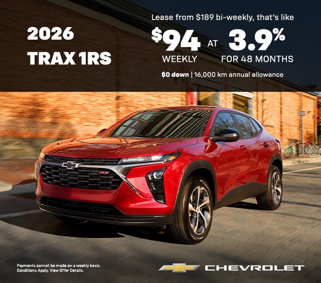 Red 2026 Chevrolet Trax 1RS SUV on a street; lease offer $94 weekly at 3.9% for 48 months, $0 down.
